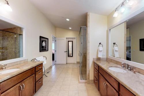 a large bathroom with two sinks and a shower at Seasons 331 - Penthouse in Sandpoint