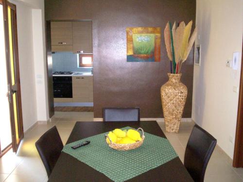 a dining room with a table with a bowl of fruit at Bono Vacanze Villa San Marco Luxury Holidays Homes in Sciacca