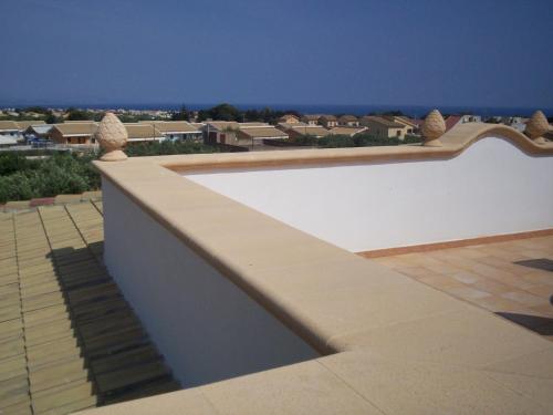 a white wall with a view of a city at Bono Vacanze Villa San Marco Luxury Holidays Homes in Sciacca