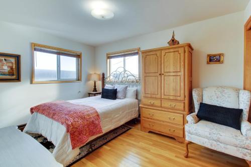 a bedroom with a bed and a dresser and a chair at Lopez Island Agate Beach Waterfront Home in Islandale