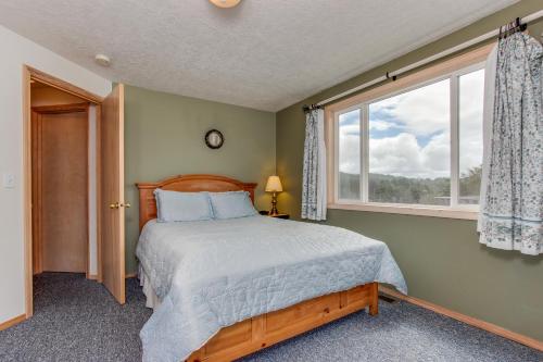 a bedroom with a bed and a window at Anchor Away at Lincoln City in Lincoln City