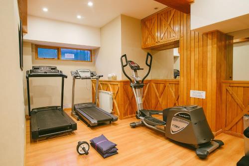 a gym with a treadmill and exercise equipment in a room at Hotel Tierra del Fuego in Ushuaia
