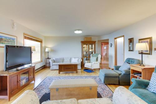 a living room with a flat screen tv at Lopez Island Agate Beach Waterfront Home in Islandale