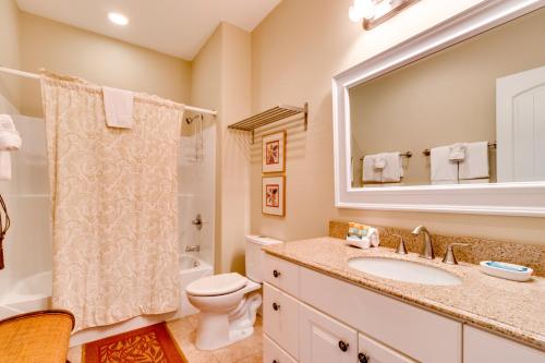 a bathroom with a sink and a toilet and a mirror at Bonnie Dune in Manzanita