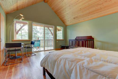 a bedroom with a bed and a desk with a computer at The Osprey Perch in Garfield