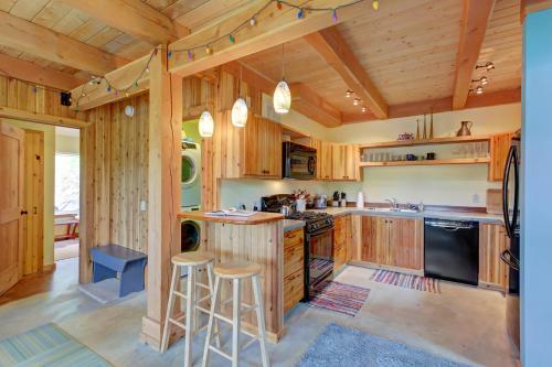 a kitchen with wooden cabinets and stools in a cabin at The Osprey Perch in Garfield