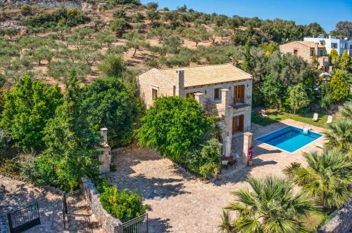 an aerial view of a house with a swimming pool at Cretan Exclusive Villas in Agia Triada