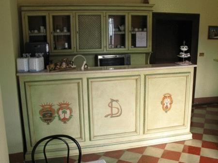 a kitchen with a counter and a chair at Palazzo Senape De Pace in Gallipoli