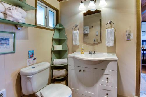 a bathroom with a toilet and a sink at Dulcinea's Cabin in Yachats