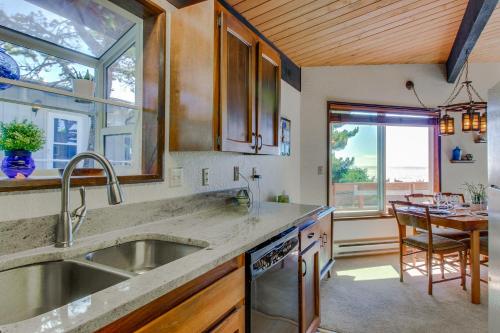 a kitchen with a sink and a table and a window at Arrow Point in Newport