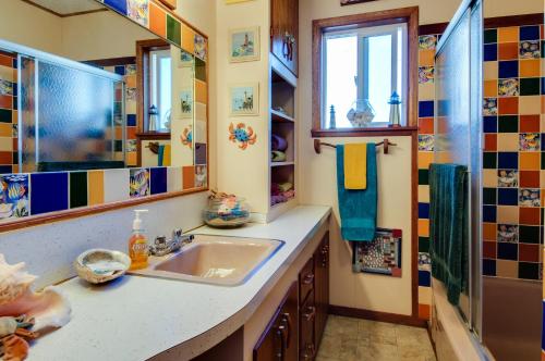 a bathroom with a sink and a shower at Darrs Beach Cottage in Neskowin