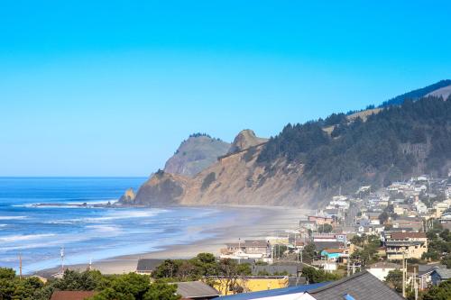 a view of a beach with houses and mountains at Ocean View Terrace in Lincoln City