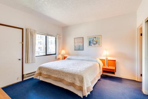 a bedroom with a bed and a window at Sand & Sea: The Promenade (100) in Seaside