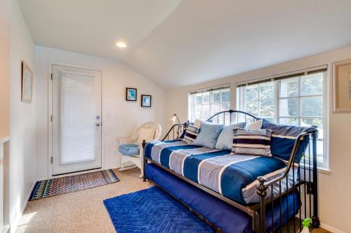 a bedroom with a bed and a window at Hale Kaalawai in Oceanside