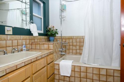 a bathroom with a tub and a sink and a shower at Headland Cove Retreat in Mendocino