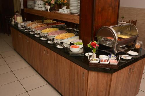 a buffet line with many different types of food at HsHotelaria - Filial Bombinhas in Bombinhas