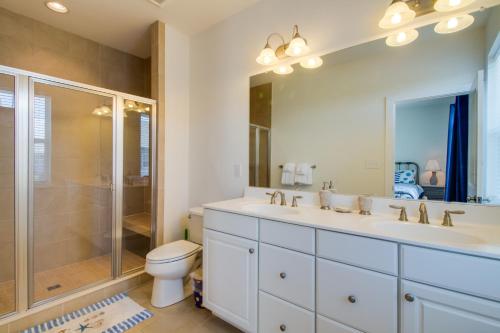 a bathroom with a sink and a shower and a toilet at Broad Marsh Beach House in Ocean City