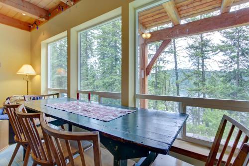 a dining room with a table and some windows at The Osprey Perch in Garfield