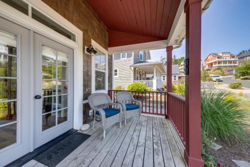 a porch with two chairs and a table at Dog Paddle in Lincoln City