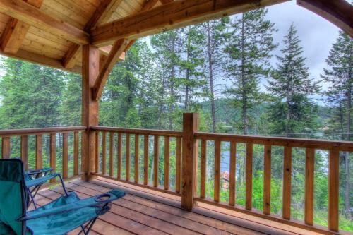 a porch of a cabin with a chair on it at The Osprey Perch in Garfield