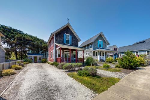 a home with a red and blue house at Dog Paddle in Lincoln City