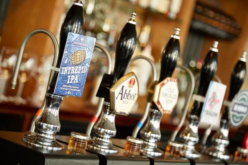 a group of bottles of beer on a table at Lea Gate by Greene King Inns in Preston