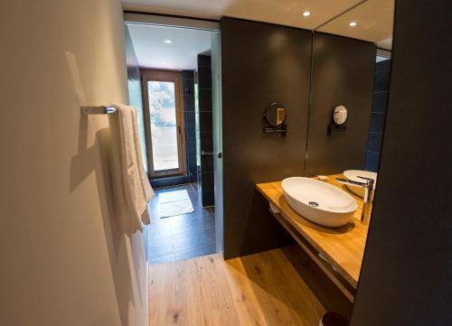 a bathroom with a sink and a toilet on a counter at Rieslingquartier - Mosel Wein Hotel in Kröv