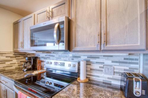 a kitchen with a stove and a microwave at Lakeview Marina Place in Dillon