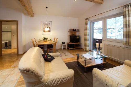 a living room with a couch and a table at Vicky Apartments in Niederau