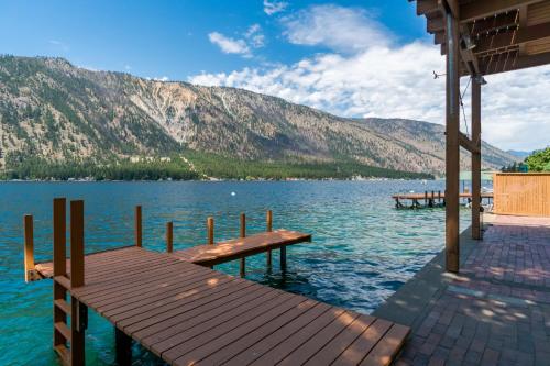 a dock on a lake with mountains in the background at Clear Water in Shrine Beach