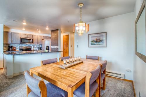 a kitchen and dining room with a wooden table and chairs at Lakeview Marina Place in Dillon