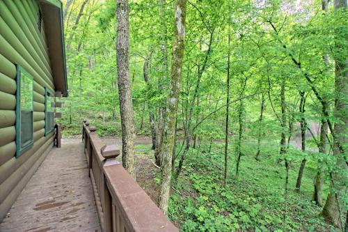 a bench on a building in the woods at Tree Song Mountain Creek Cabin in Ellijay