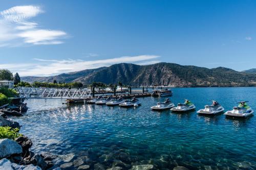 a group of boats in a body of water at Royal View on Lakeshore in Chelan
