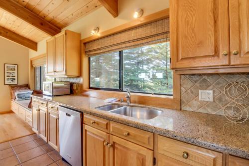 a kitchen with wooden cabinets and a sink and a window at Audubon House in Sea Ranch