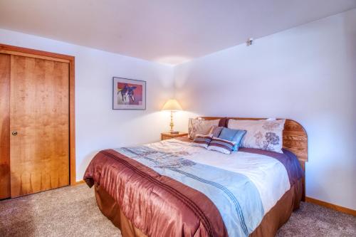 a bedroom with a large bed and a wooden door at Lakeview Marina Place in Dillon