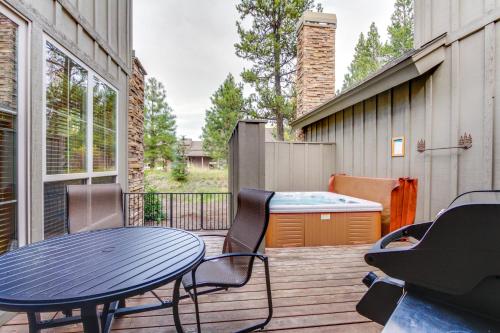 a patio with a table and chairs and a hot tub at 23 Fremont Crossing Sunriver in Sunriver