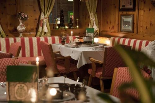 a dining room with a table and chairs and candles at Hotel Metzgerwirt in Fieberbrunn