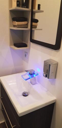 a bathroom with a white counter and a mirror at Studio Appartement in Speichersdorf