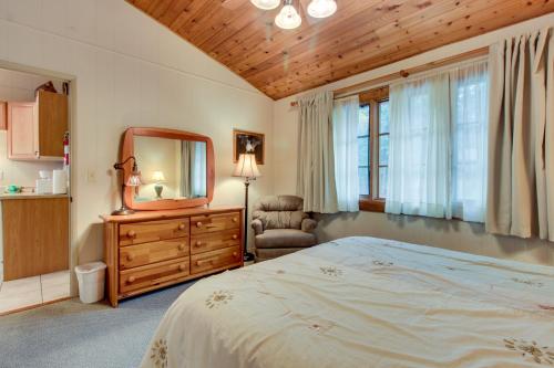 a bedroom with a bed and a mirror and a chair at Bay Point Lakefront 1B Up in Whitefish
