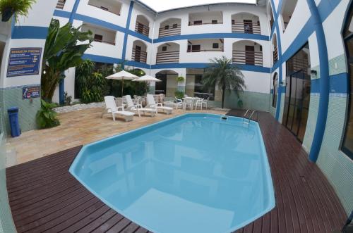 a swimming pool in front of a building at HsHotelaria - Filial Bombinhas in Bombinhas