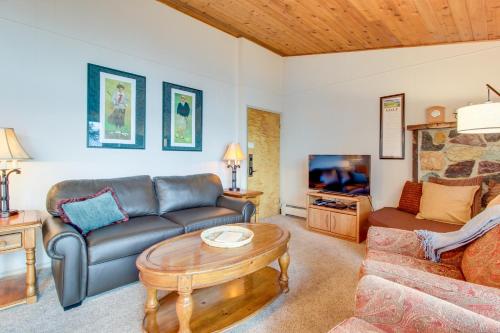 a living room with a couch and a table at Bay Point Lakefront 1B Up in Whitefish
