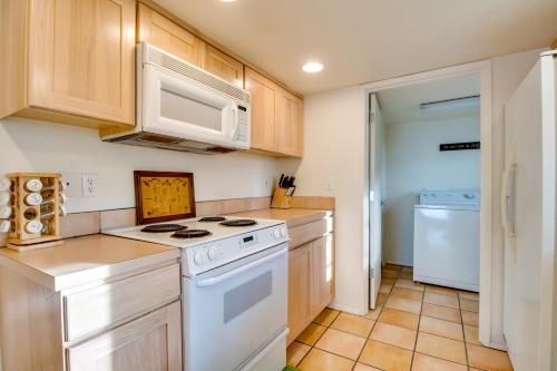 a kitchen with a white stove and a microwave at Hale Kaalawai in Oceanside