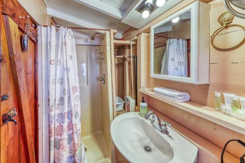 a bathroom with a sink and a shower curtain at Pearl Bay Holiday in Grand Isle