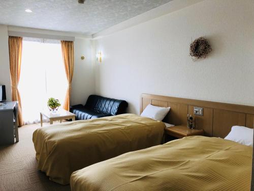 Postel nebo postele na pokoji v ubytování Hotel Belle-Cour Inomata