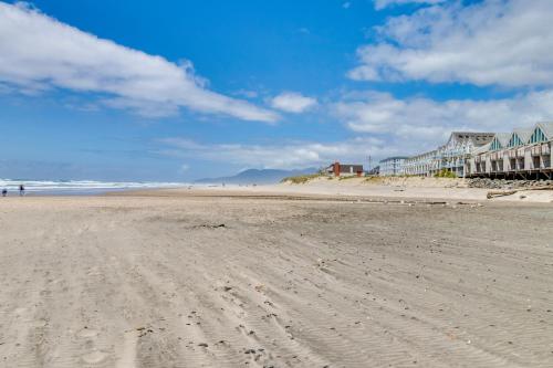 a sandy beach with footprints in the sand at Cozy Coast Modern in Nedonna Beach