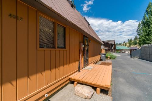 a wooden bench sitting outside of a building at Clear Water in Shrine Beach