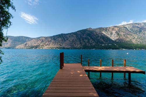 a dock on a lake with mountains in the background at Clear Water in Shrine Beach
