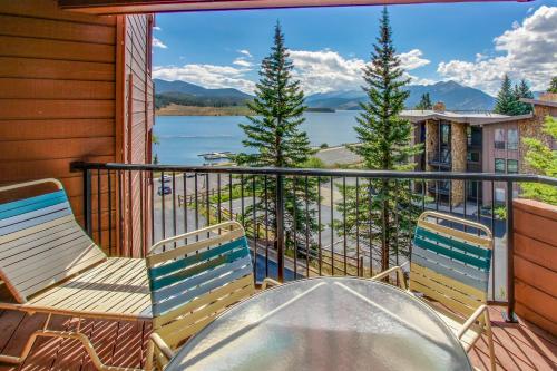 a balcony with chairs and a table and a view of a lake at Lakeview Marina Place in Dillon