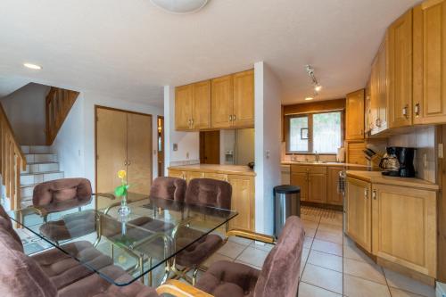 a kitchen and dining room with a glass table and chairs at Clear Water in Shrine Beach
