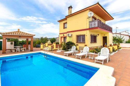 a villa with a swimming pool and a house at Catalunya Casas Blissful Costa Dorada Escape with private pool in Bisbal del Penedès